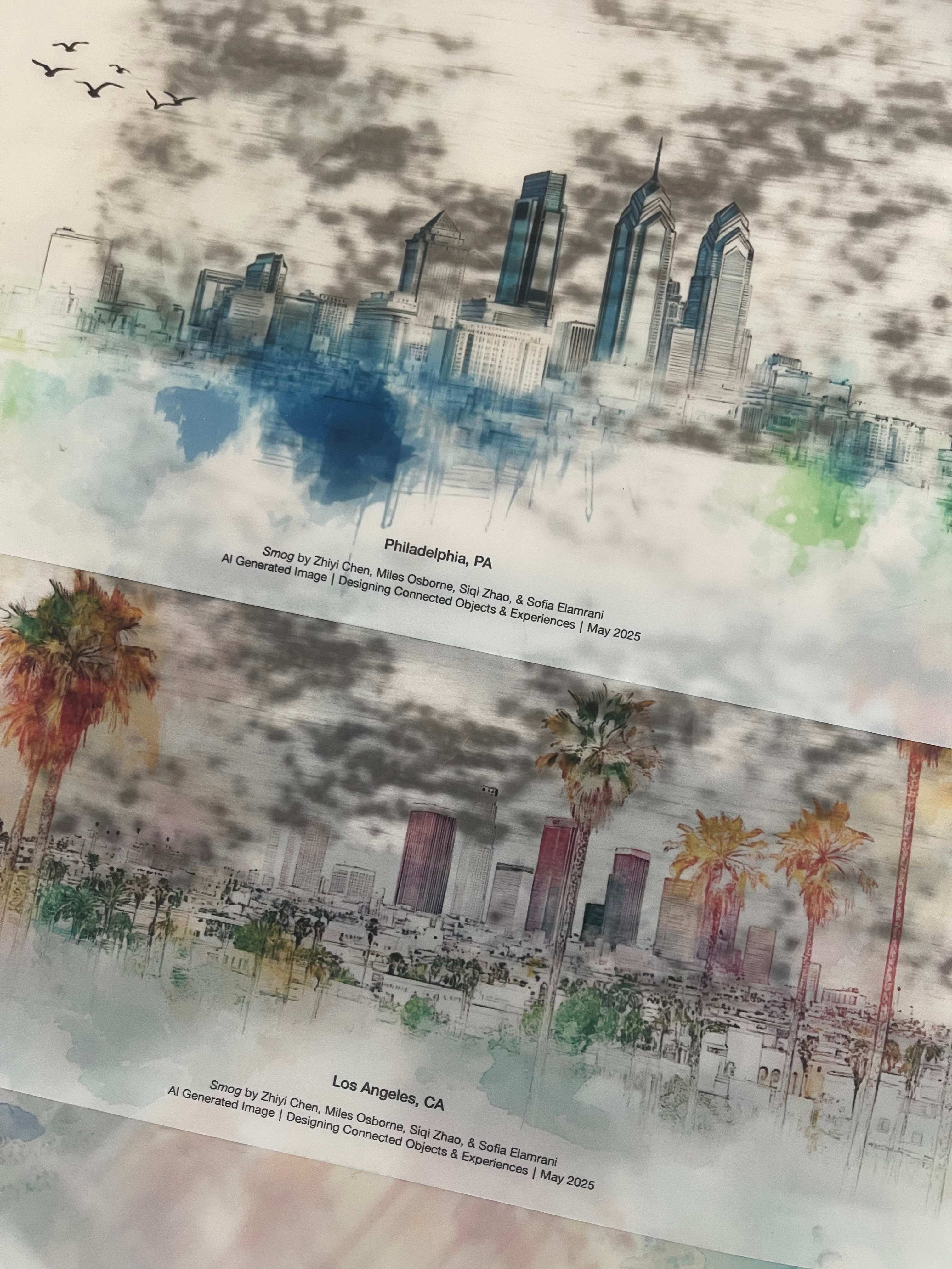 Finished prints — charcoal smog deposited across the Philadelphia and Los Angeles skylines.